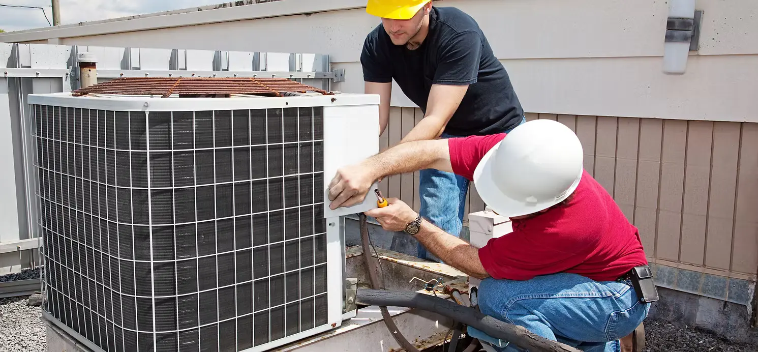 HVAC technician servicing an outdoor condenser